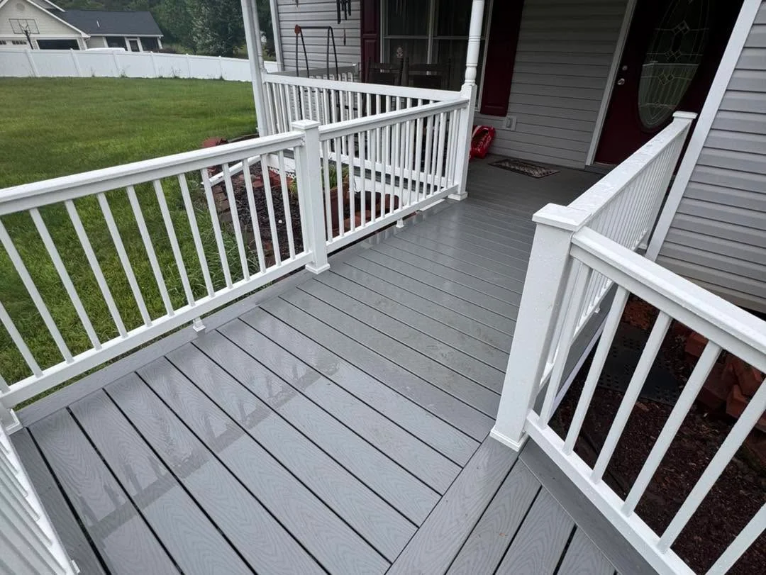 Gray composite deck with white aluminum railings and multi-level design